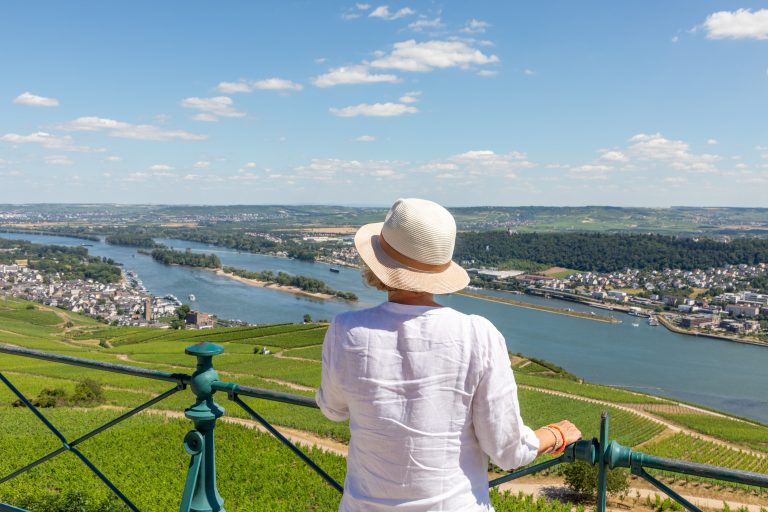 woman enjoys the beautiful view from the platform at Niederwald monument to the river rhine valley