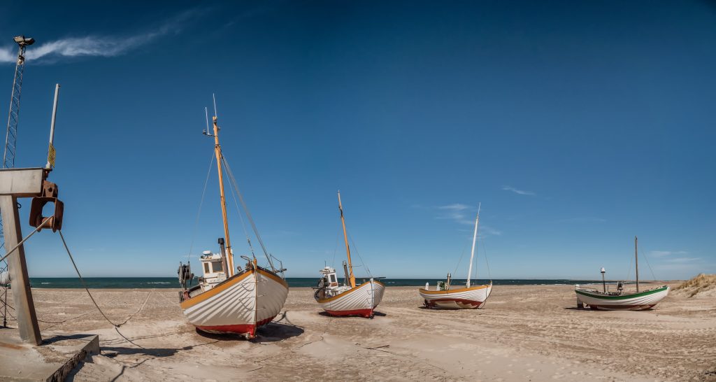 Coastal fishing boats on the beach at SletteStrand at the North Sea in Denmark